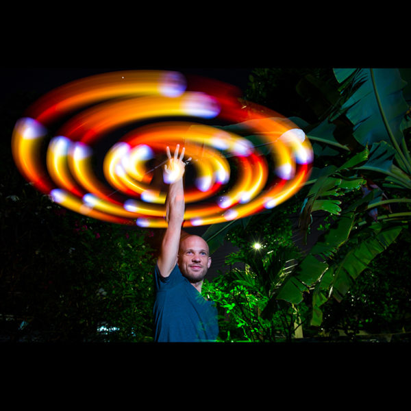 customer Thomas Johansson spinning podpoi at an event in fire mode